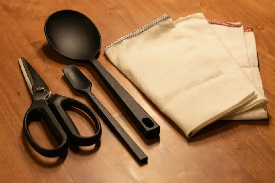 Soft chew joint supplements arranged on a wooden table next to a measuring scoop